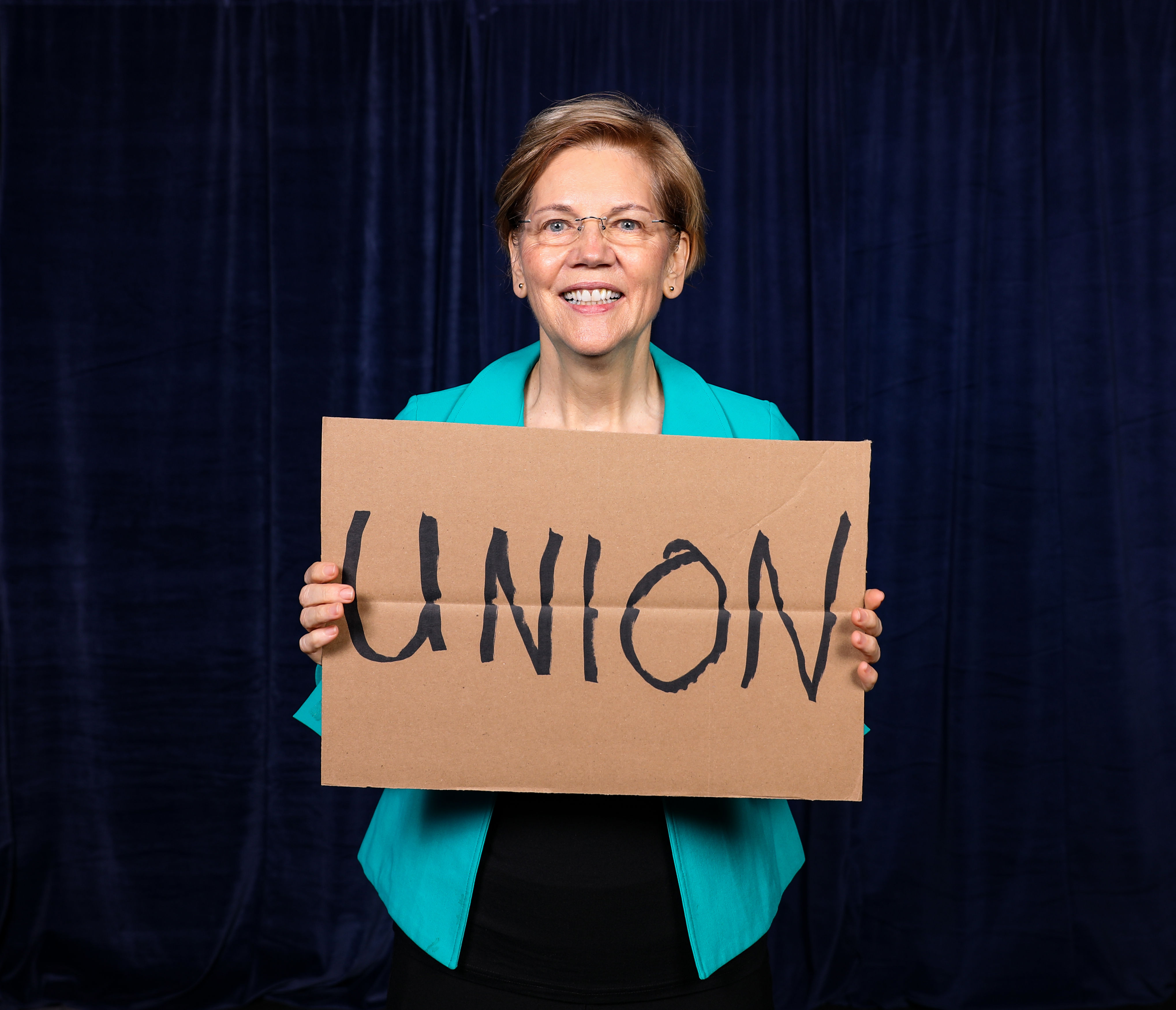 Senator Warren Holding a UNION Sign